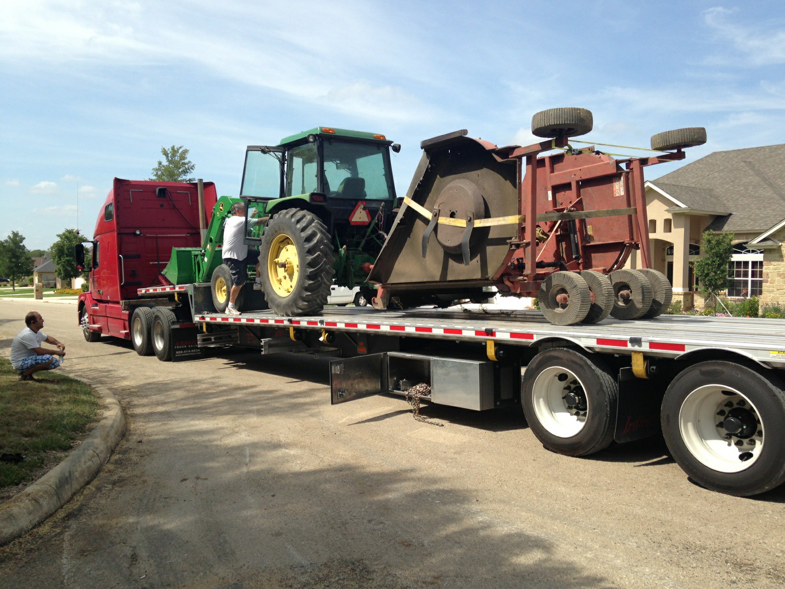 Tractor with batwing mower prepared for transport